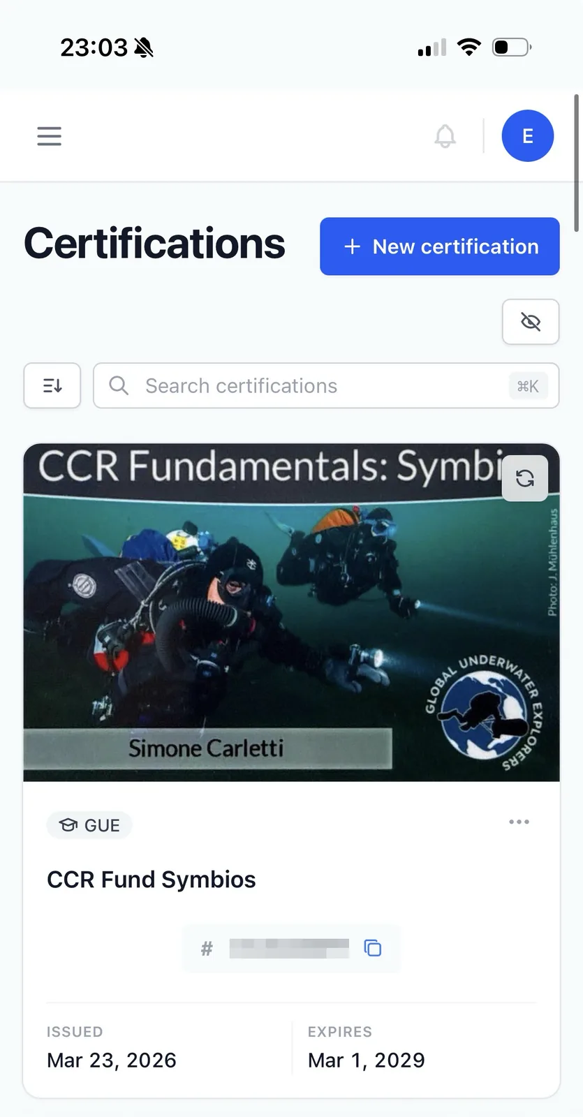 On mobile, a Divebase certification card with a one-tap button to copy its number